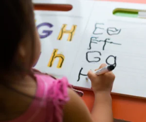 girl learning to write with worbook