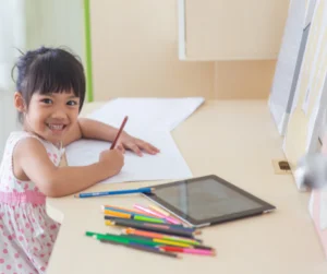 girl smiling while writing