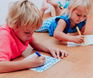 siblings writing at different stages of development
