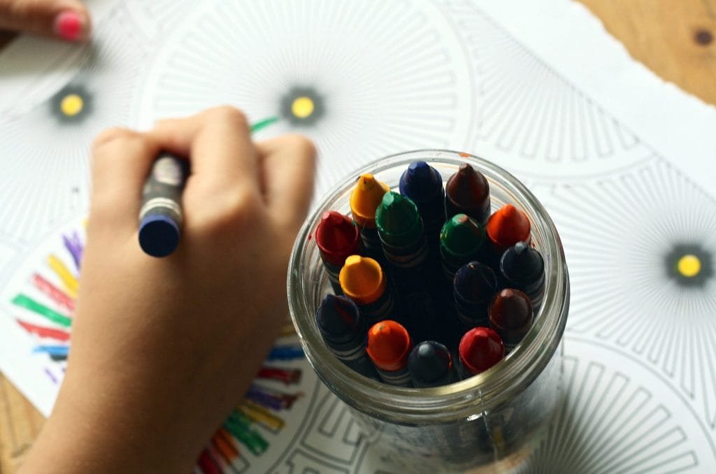 jar-of-crayons-and-child-coloring